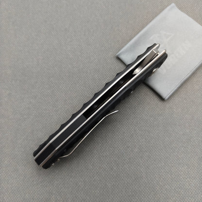 VORIXN KA008 partially open EDC folding knife showing flipper, thumb stud, pivot, and G10 handle profile.